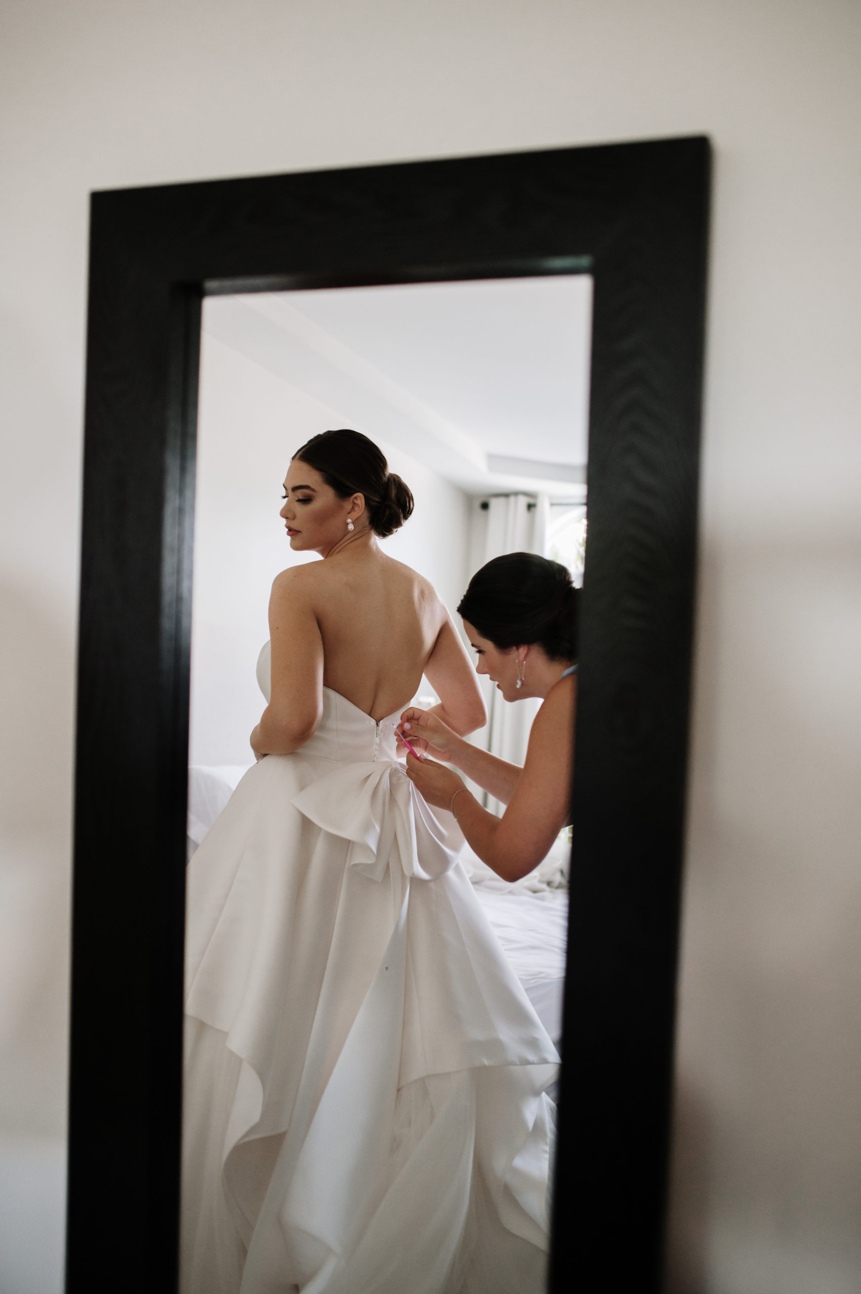 Bride is putting on her It's your day bridal dress