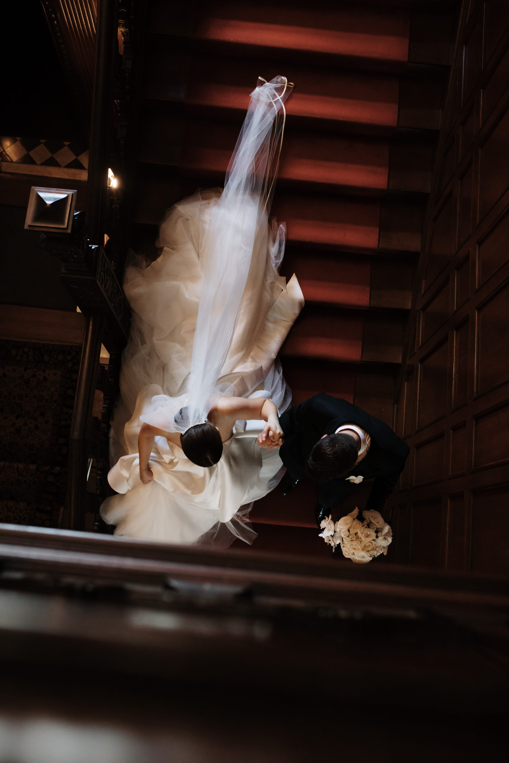 Ariel shot of bride and groom walking down the stairs at Willistead Manor